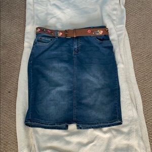 A jean skirt with a floral belt